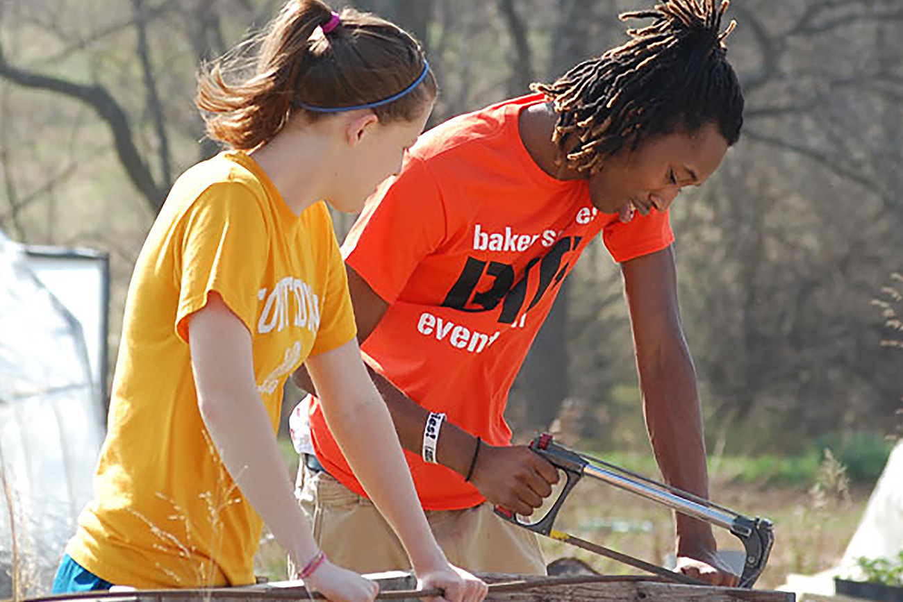 Two students helping the community through Baker Serves, a student organization.