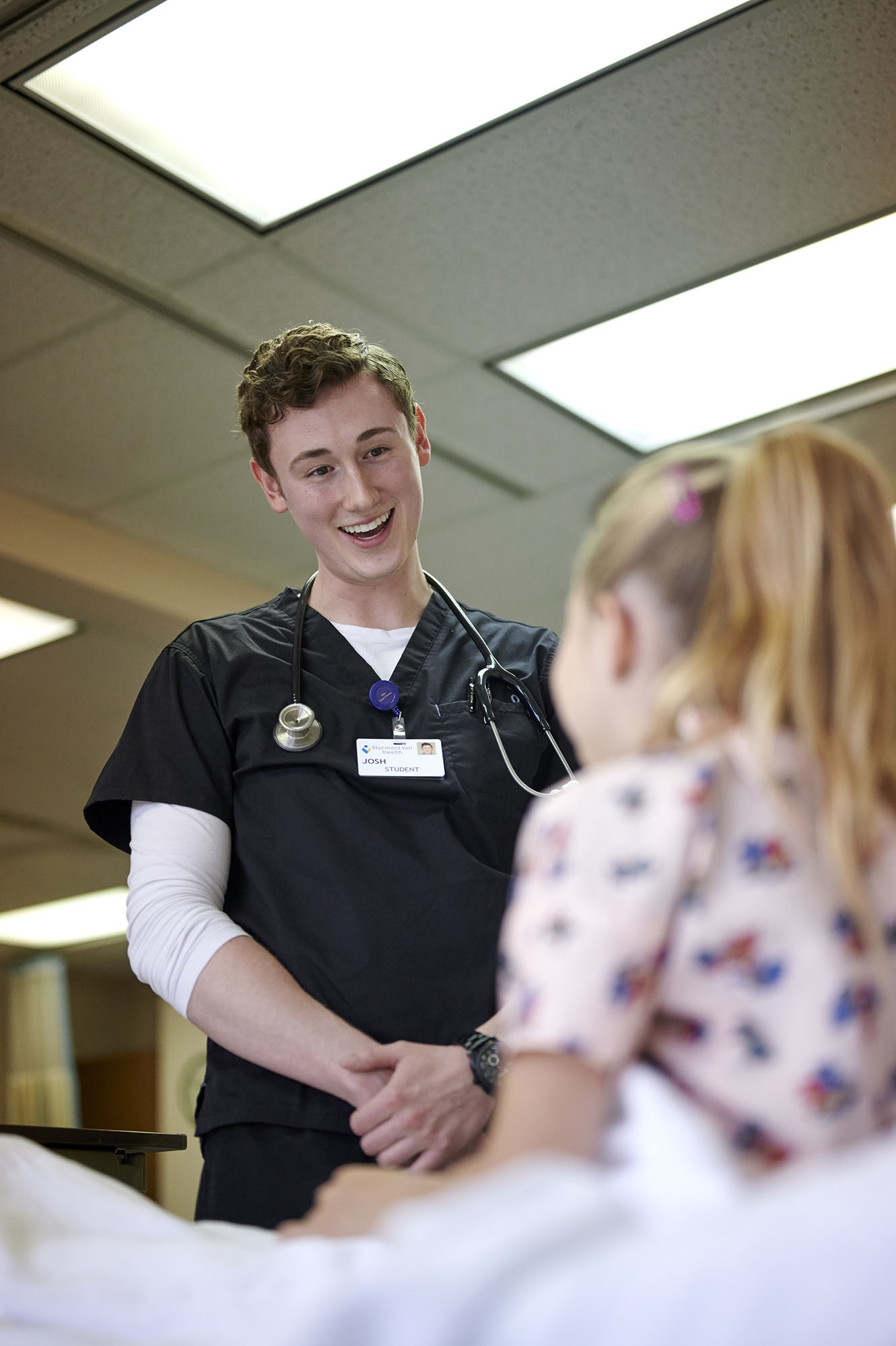 Male nursing student talking with patient