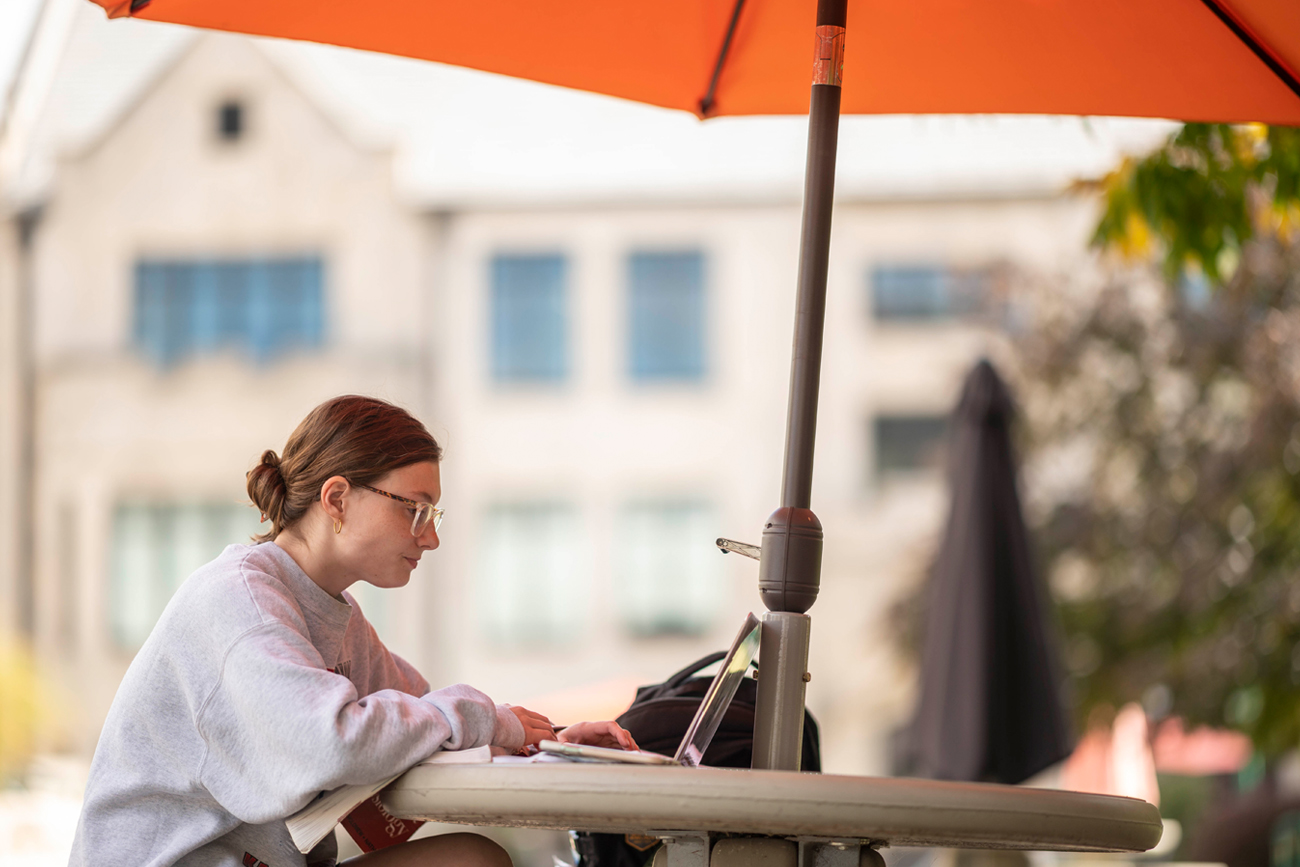 Student studying outside on campus