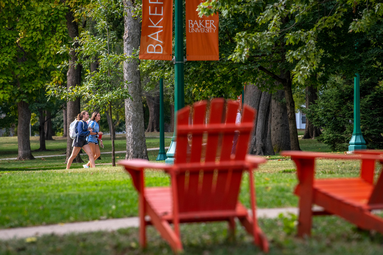 Two students walking across campus