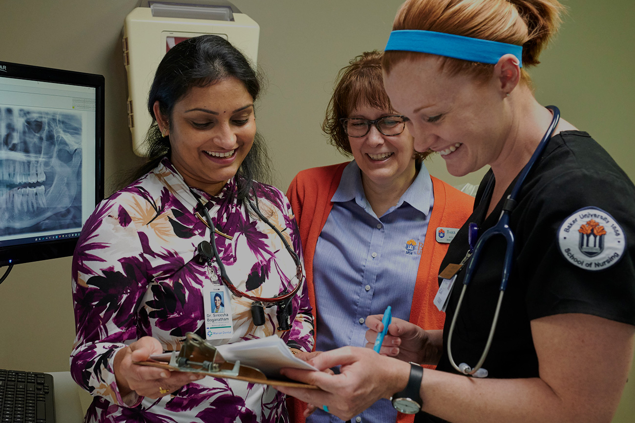 Nursing students working with faculty