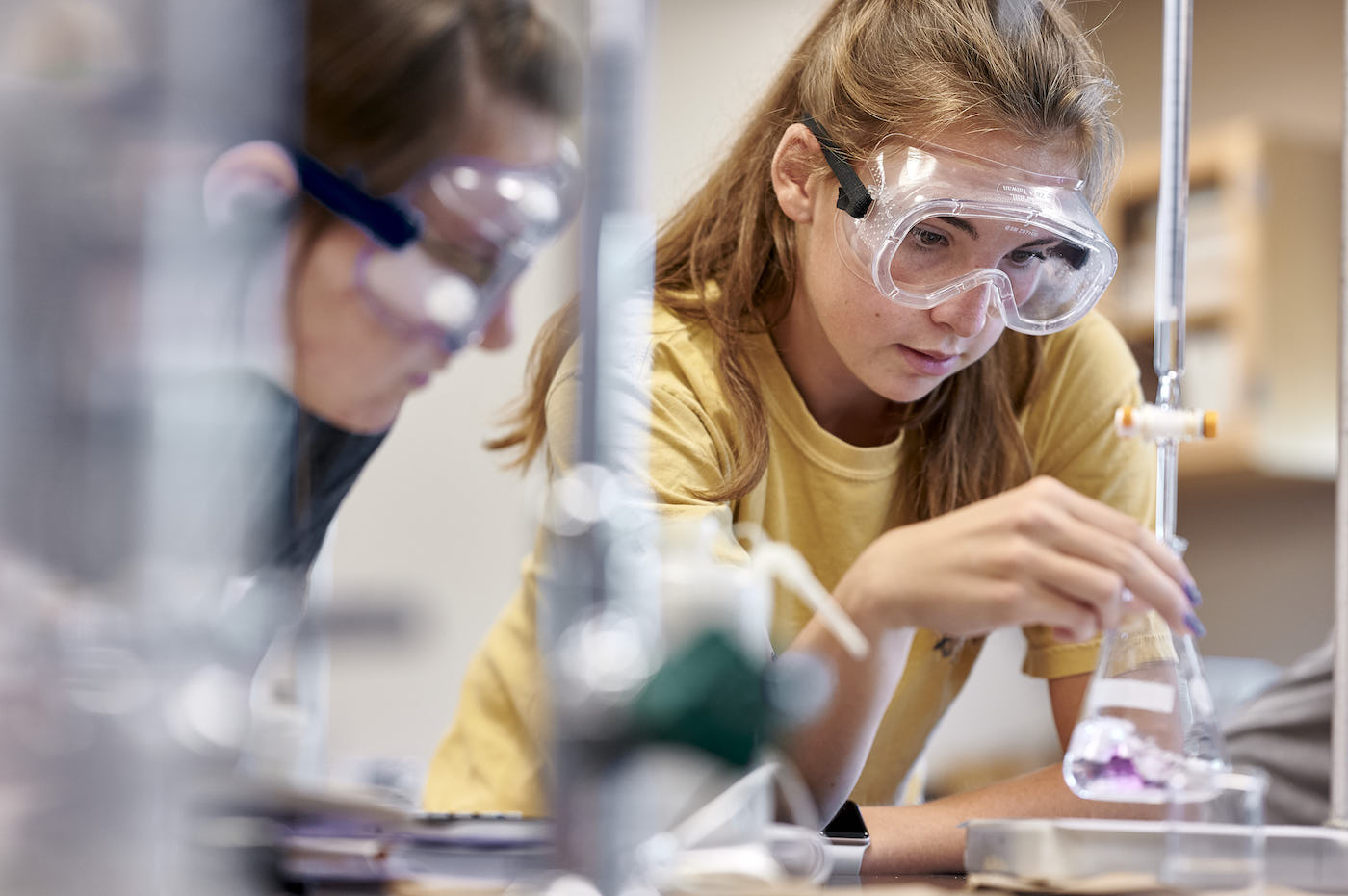 Two female students conducting experiment in lab