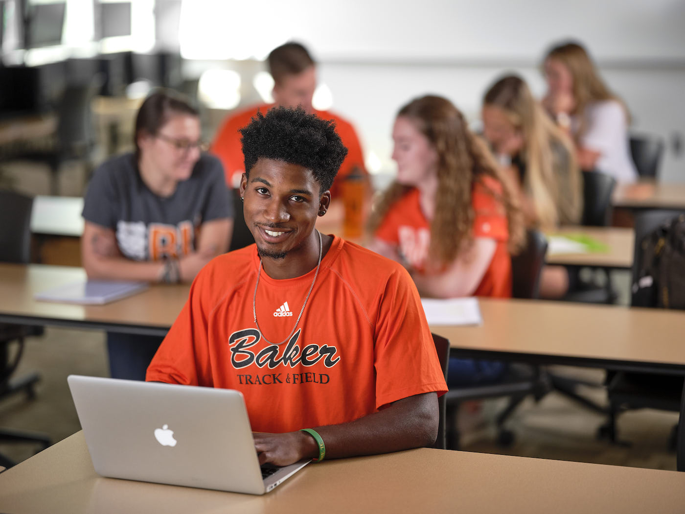 Male student using computer during class