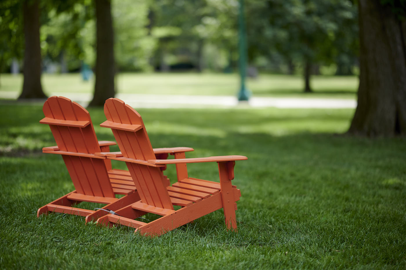 Two orange lawn chairs sitting on campus