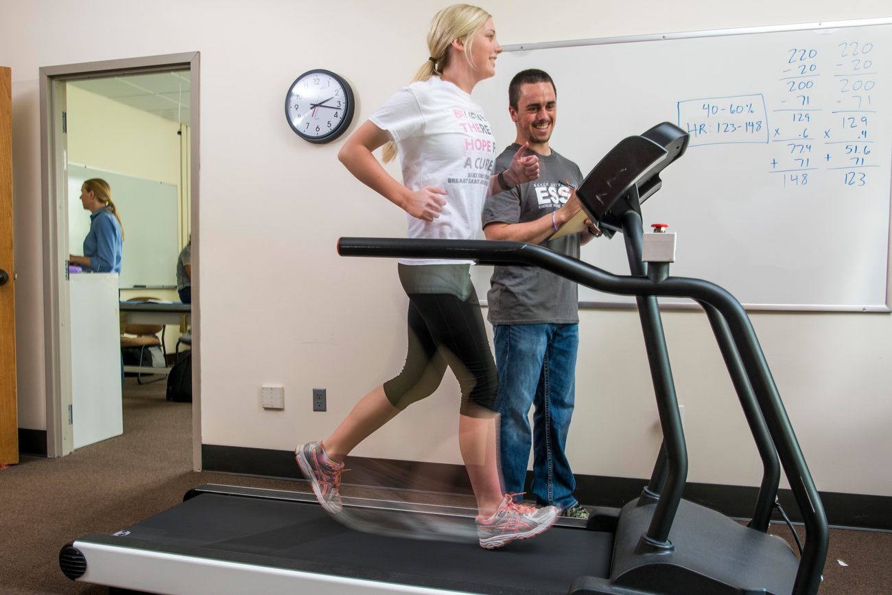 Two students working on a classroom study with a treadmill