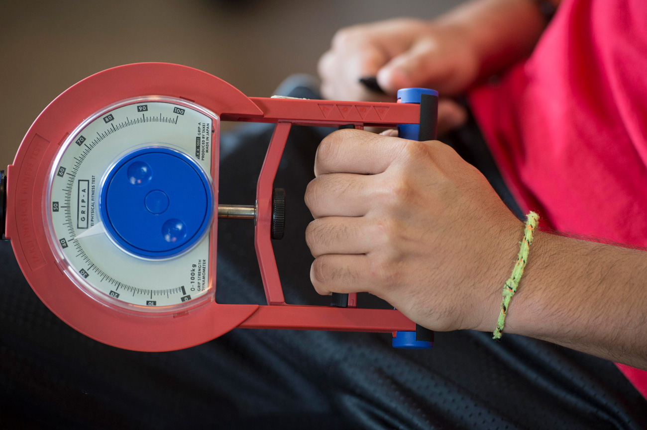 Exercise science student using hand weight tool