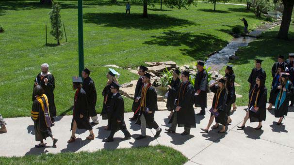 Graduating students walking on campus for commencement