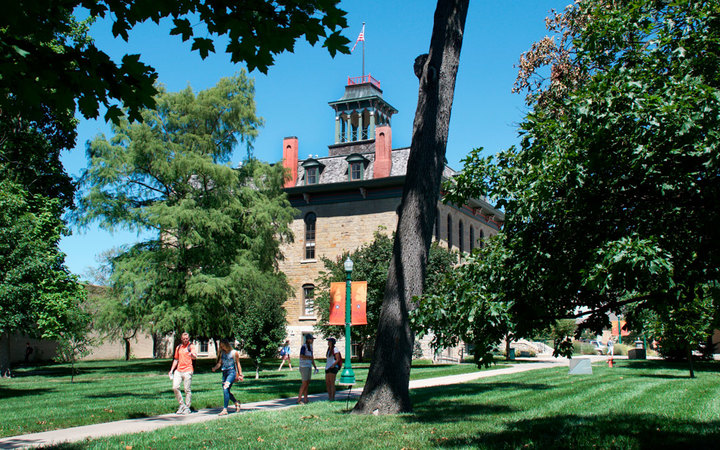 Students walking on campus in front of Parmenter Hall