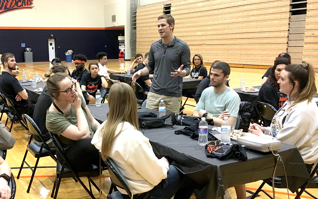 Applied health science students sitting at tables during Spring it On event