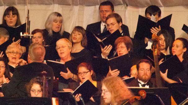 Members of community choir singing during performance