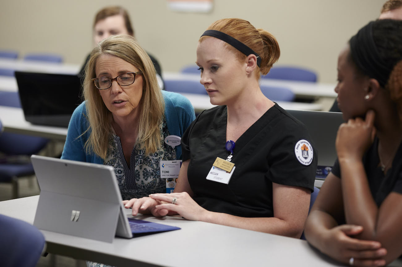 School of nursing professor helping student