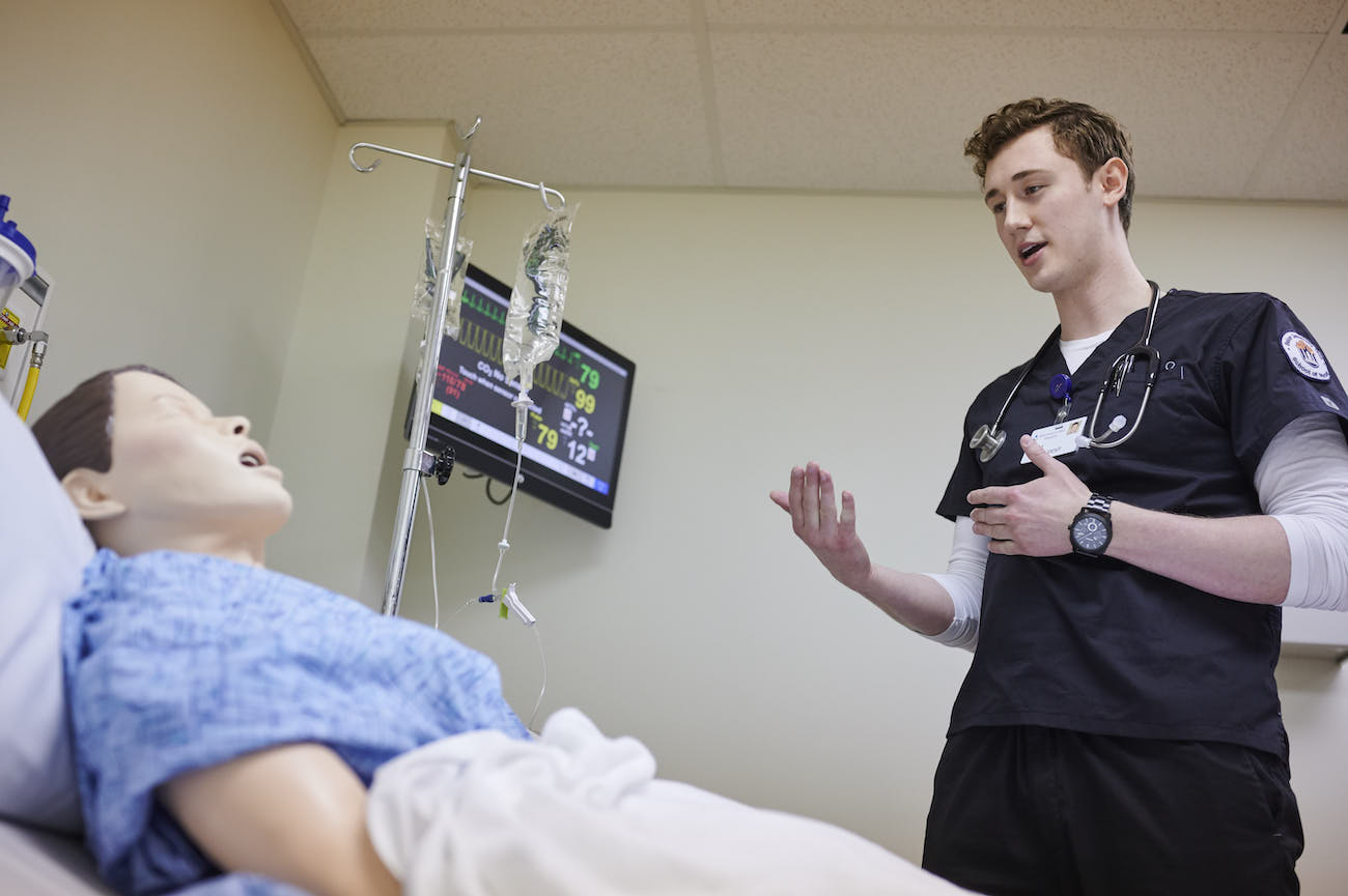 School of Nursing student practicing on simulation doll