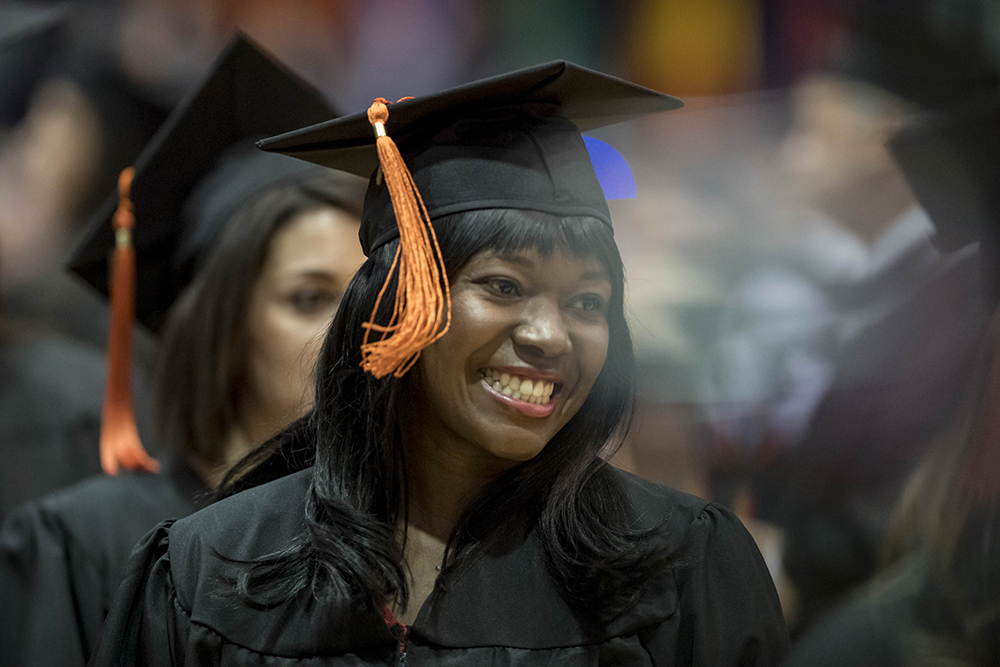 Smiling graduating student in cap and gown