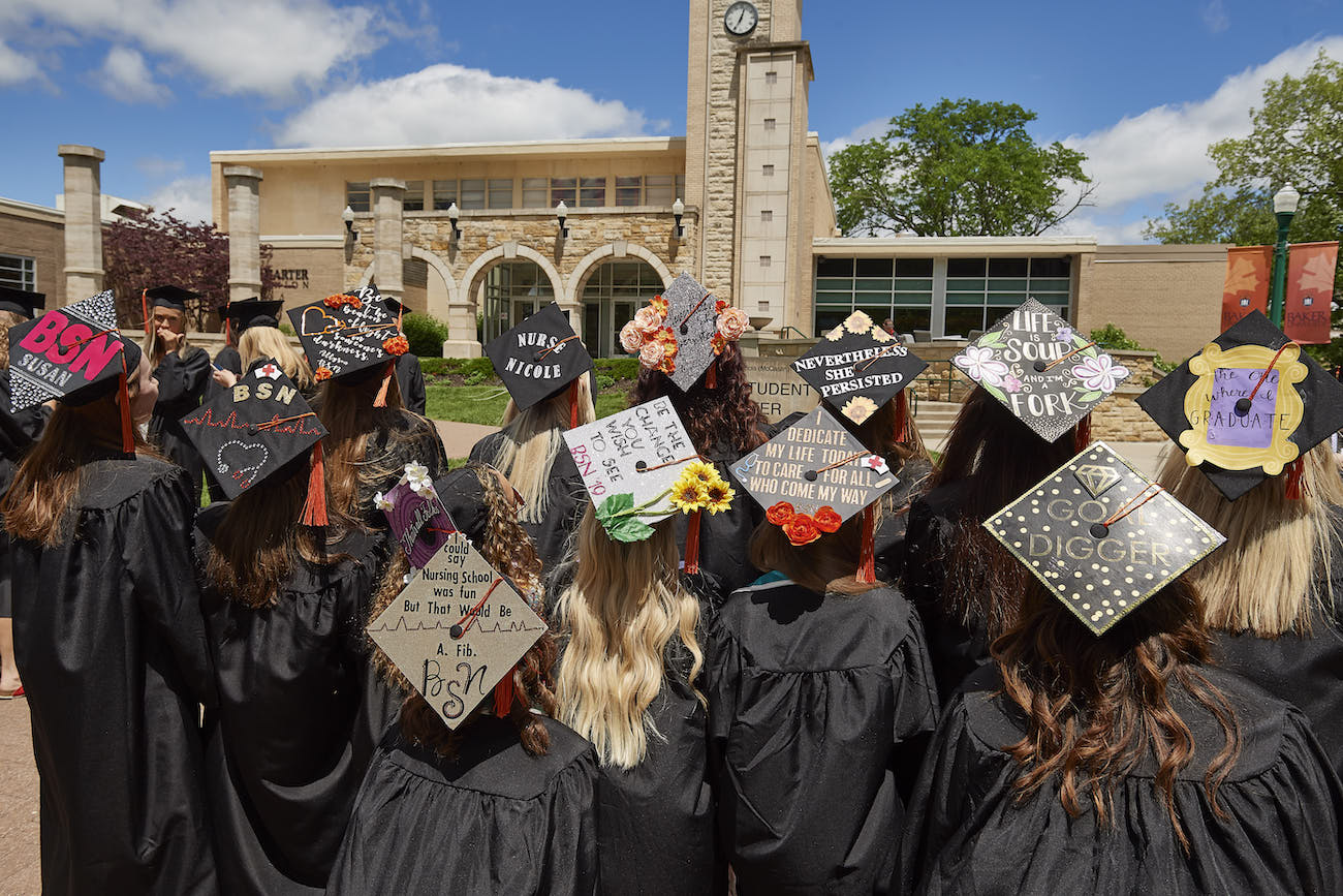 Back of students heads with decorated graduation caps