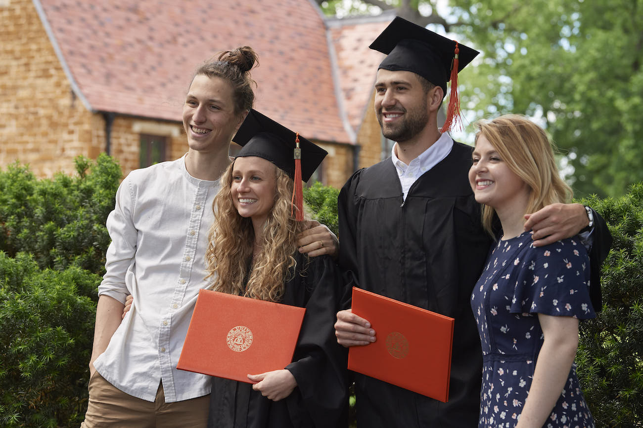 Students posing for photo in caps and gowns