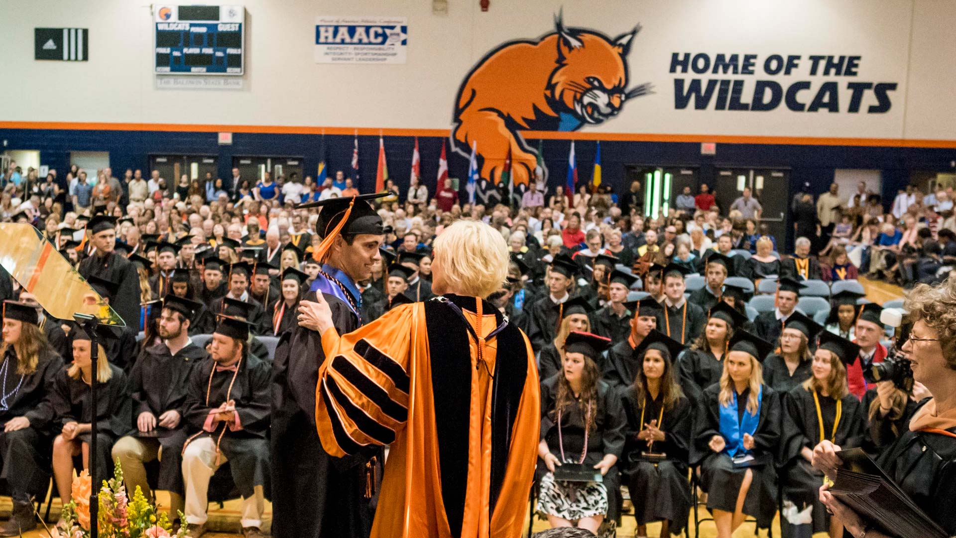 Student receiving diploma from Dr. Lynne Murray