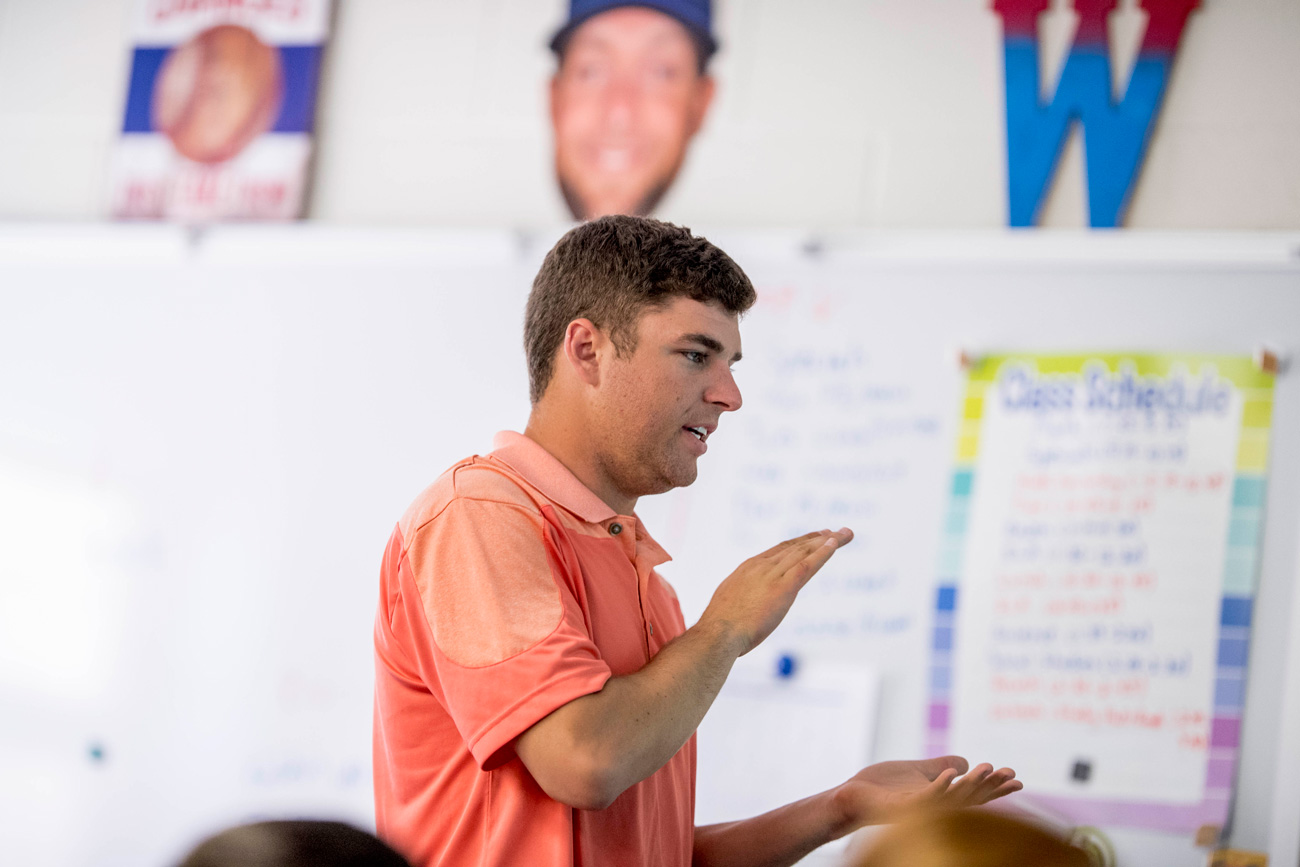 male educator giving lesson in the classroom