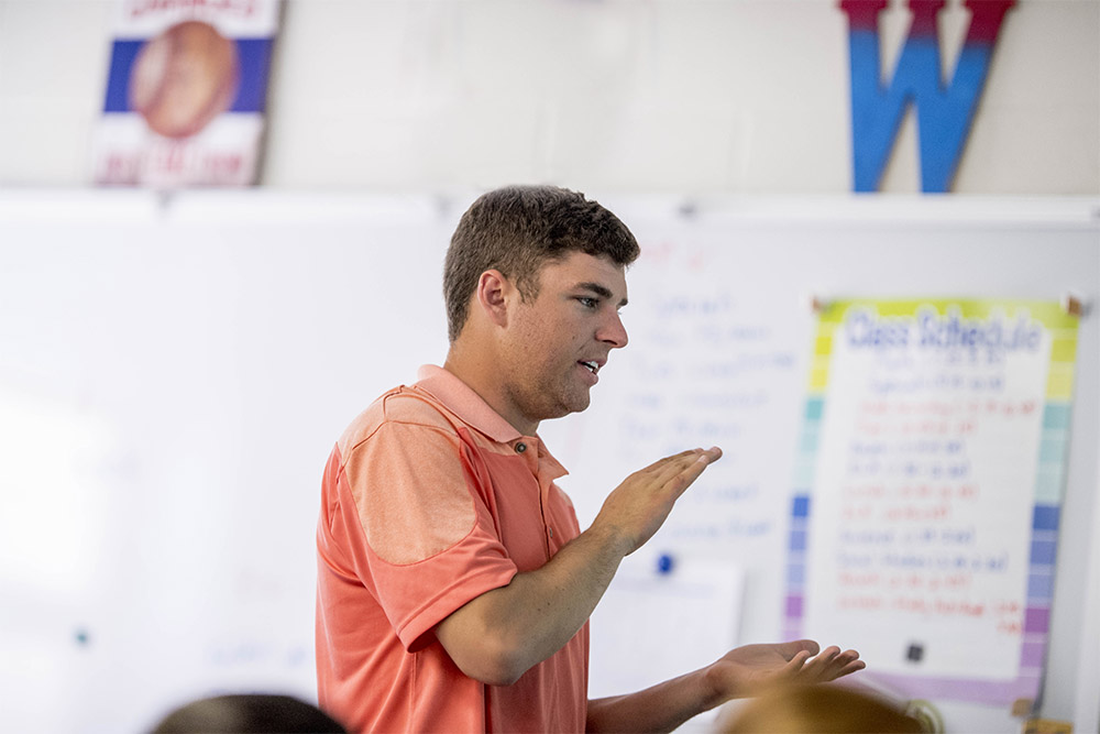 Educator walking and instructing students in class