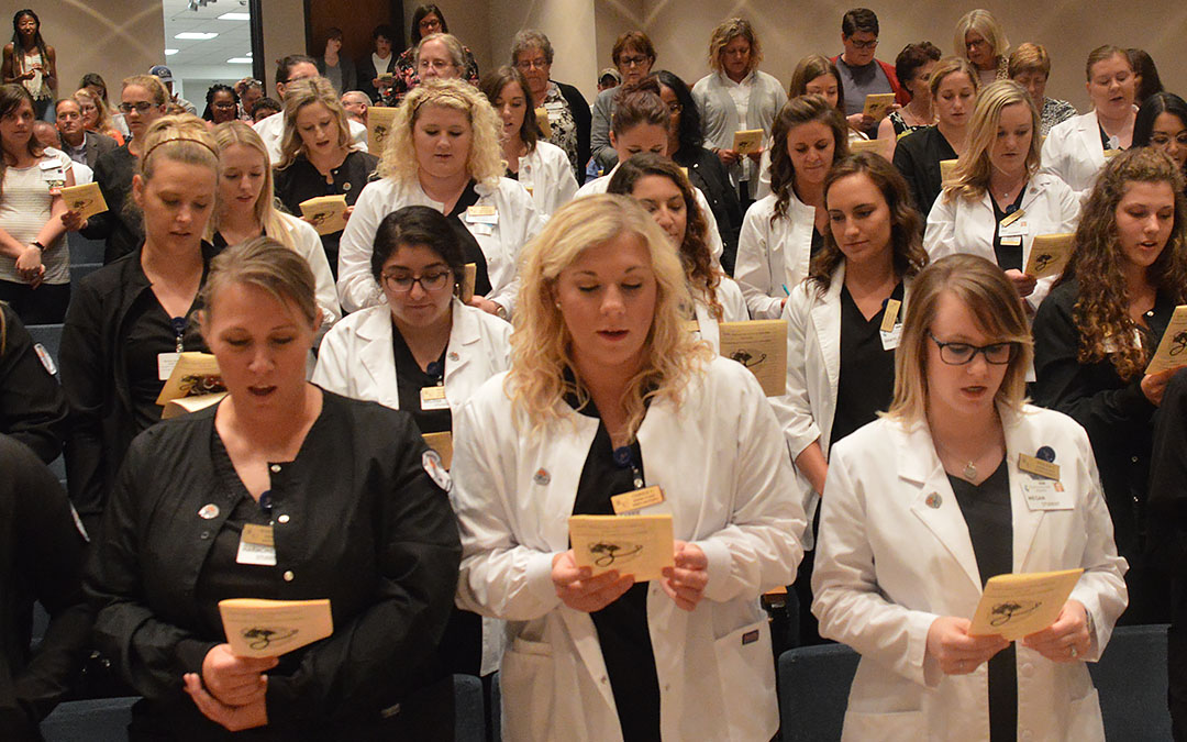 Nursing students reading pledge at Commitment to Compassion Ceremony