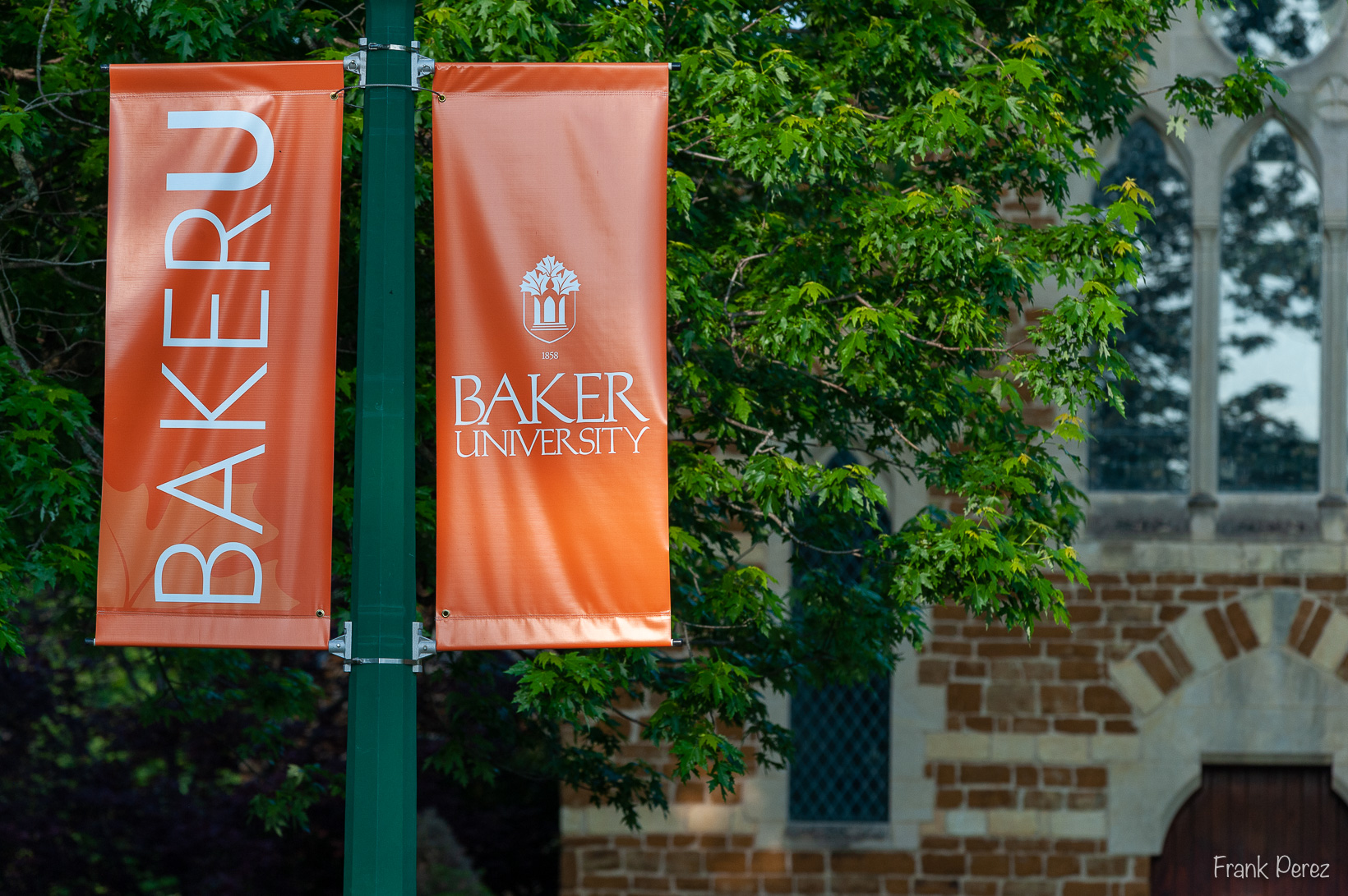 Picture of campus, Baker University orange banners on light posts on campus.