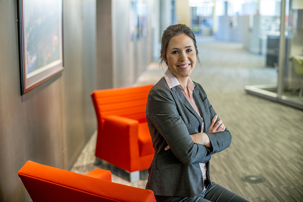 Student sitting and smiling, in professional attire