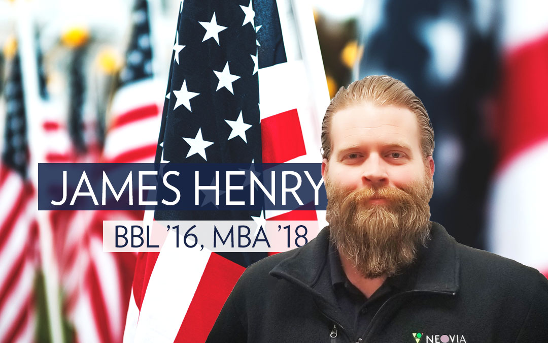 James Henry standing in front of American flags