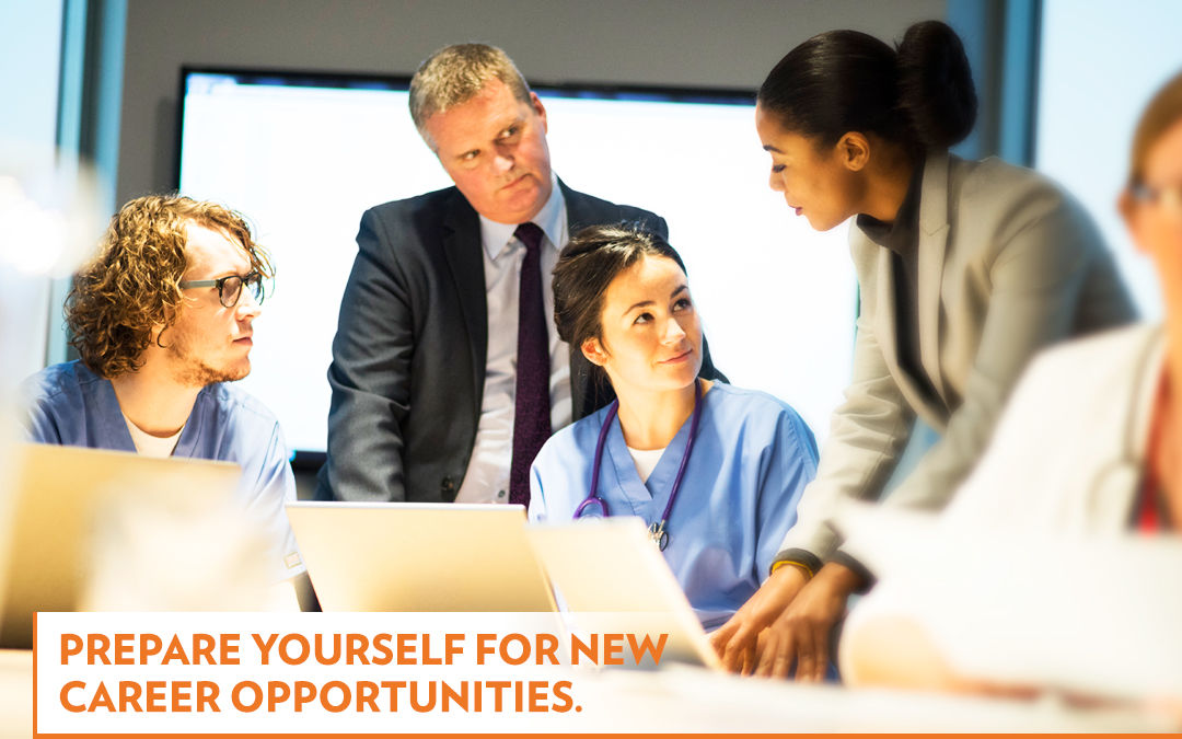 Health care administrators working around a computer