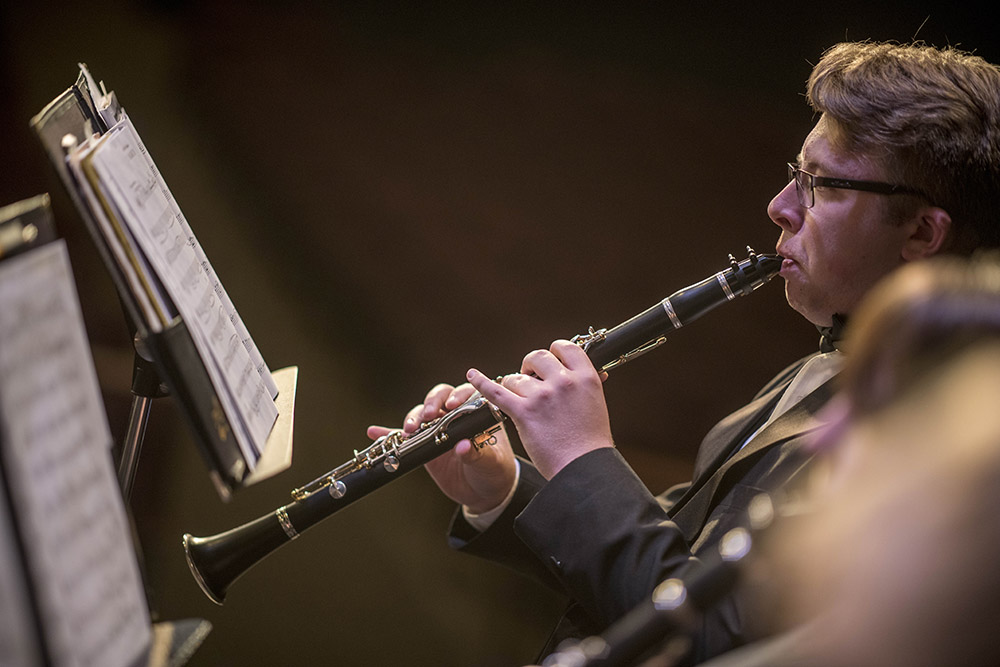 Male student playing the clarinet at a band concert