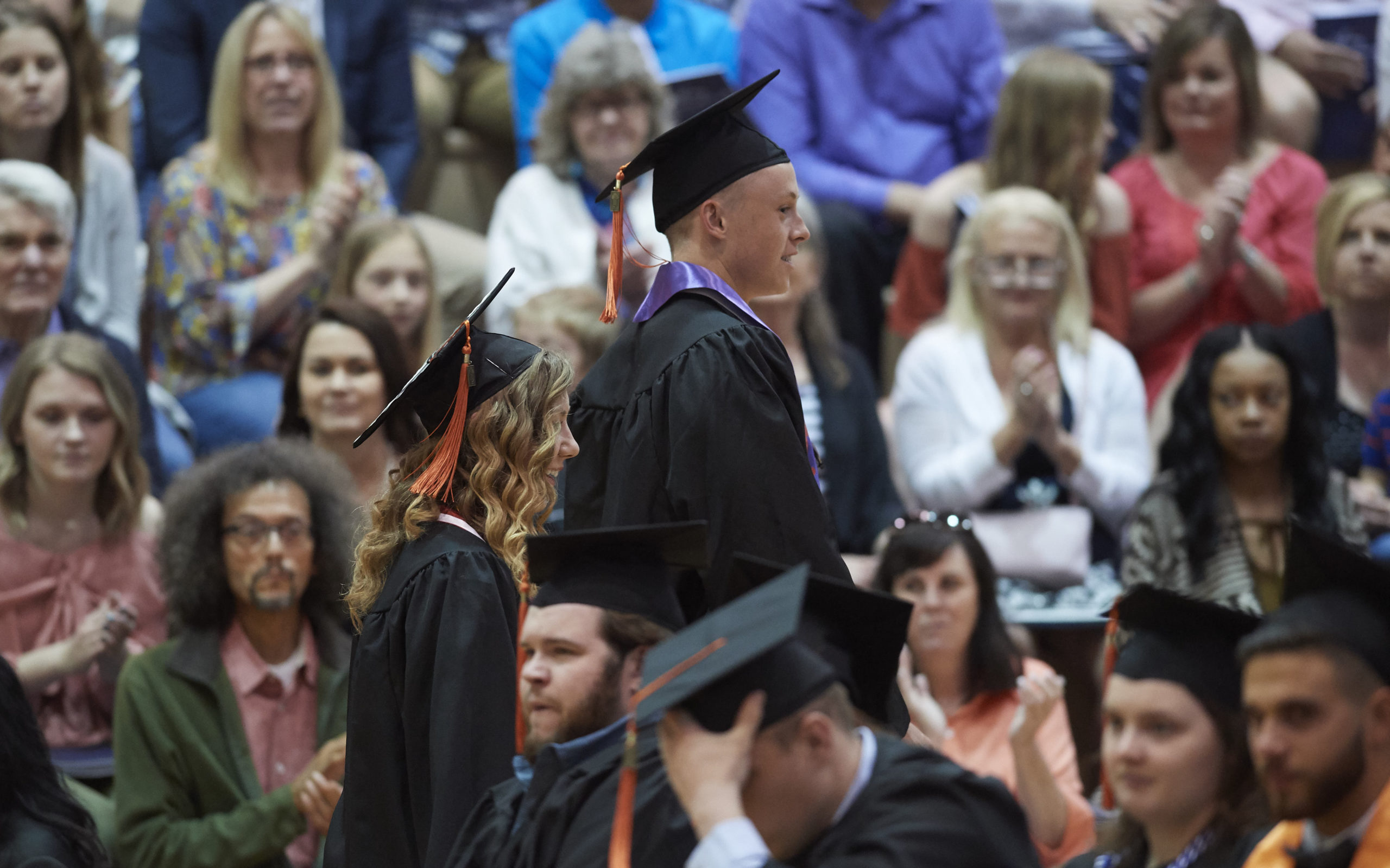 Two senior recipients of the Jabara leadership award standing at commencement ceremony
