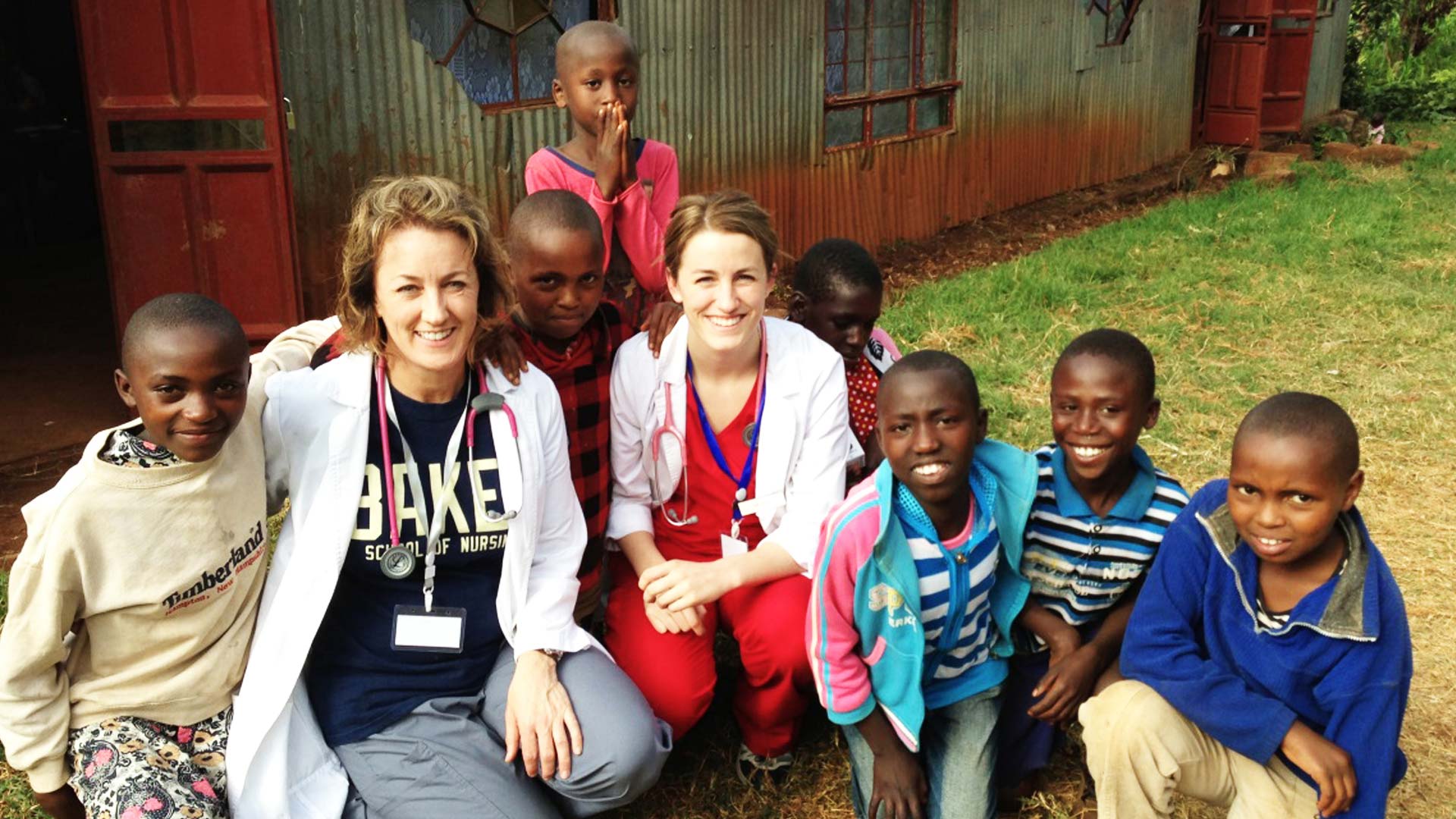 School of Nursing individuals posing with children on mission trip