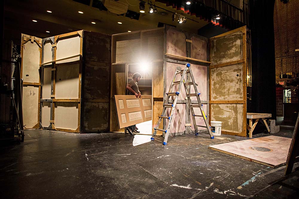 Behind the scenes of the theater set being built by a stage hand