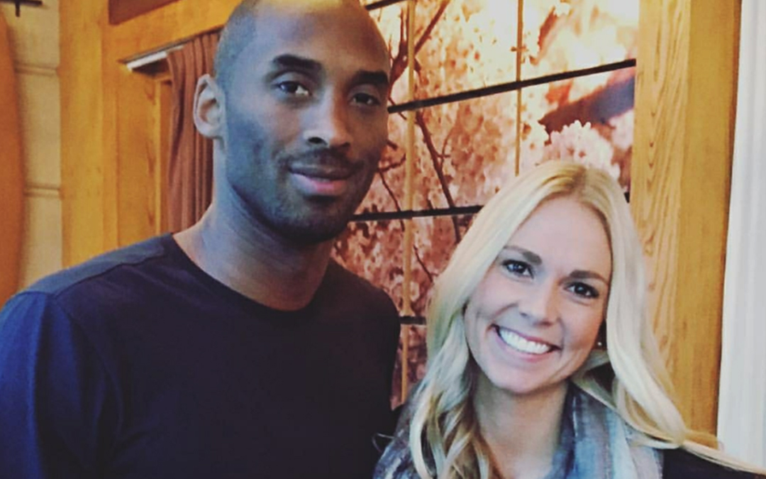 Baker alumnae Jenna Brantley stands with Kobe Bryant