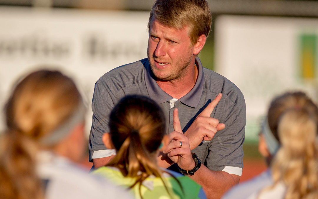 Davy Phillips, head coach of women's soccer team talking to players