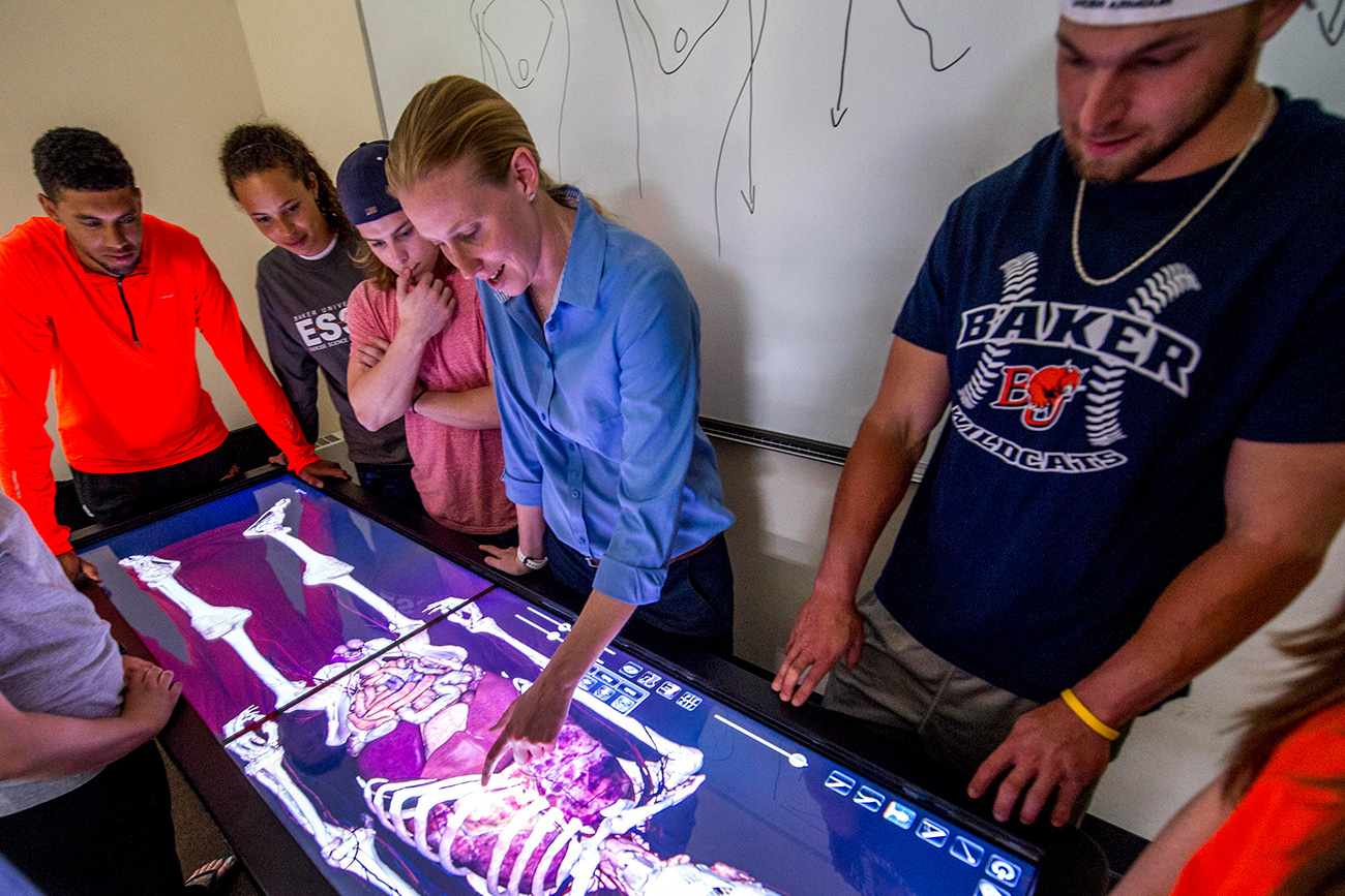 Students learning about health care using the anatomage table.