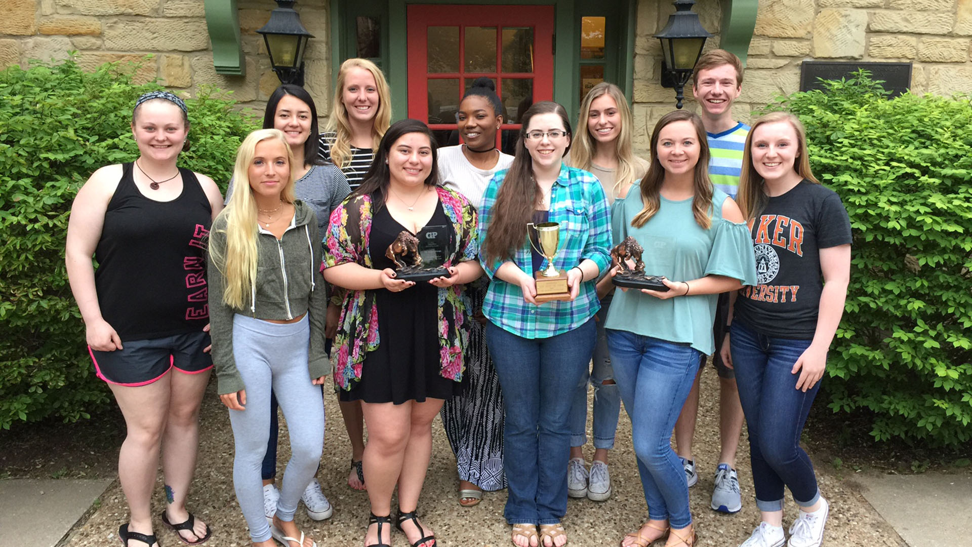 Baker Orange Newspaper staff holding awards