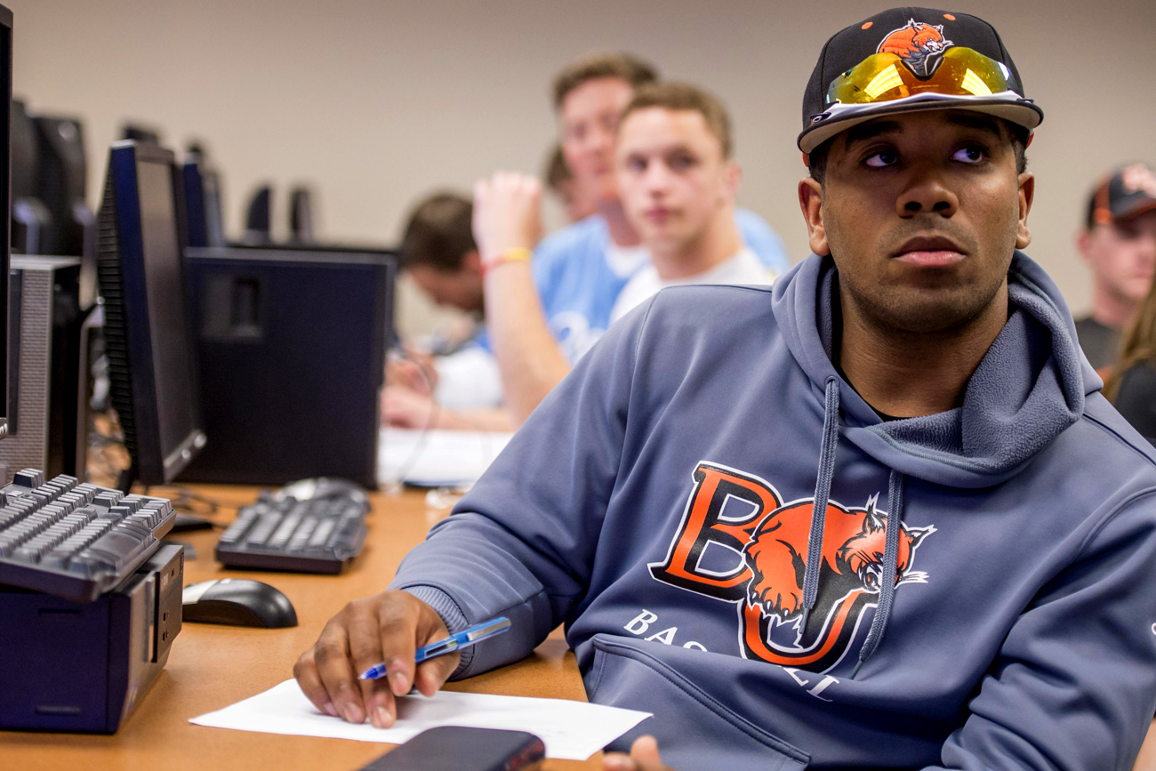 Students in business analytics classroom listening to professor