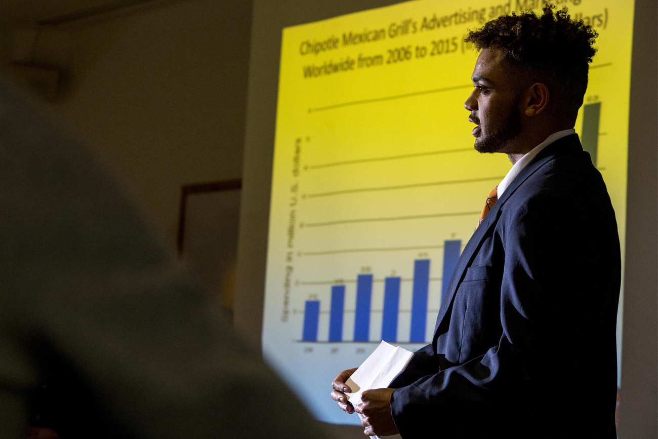 Male business student giving a presentation