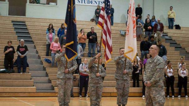 Military members holding flags