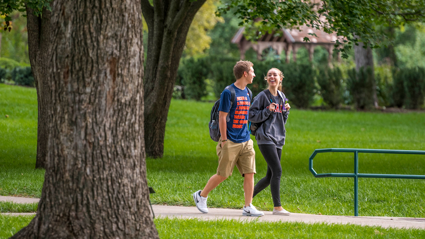 Two students walking on campus