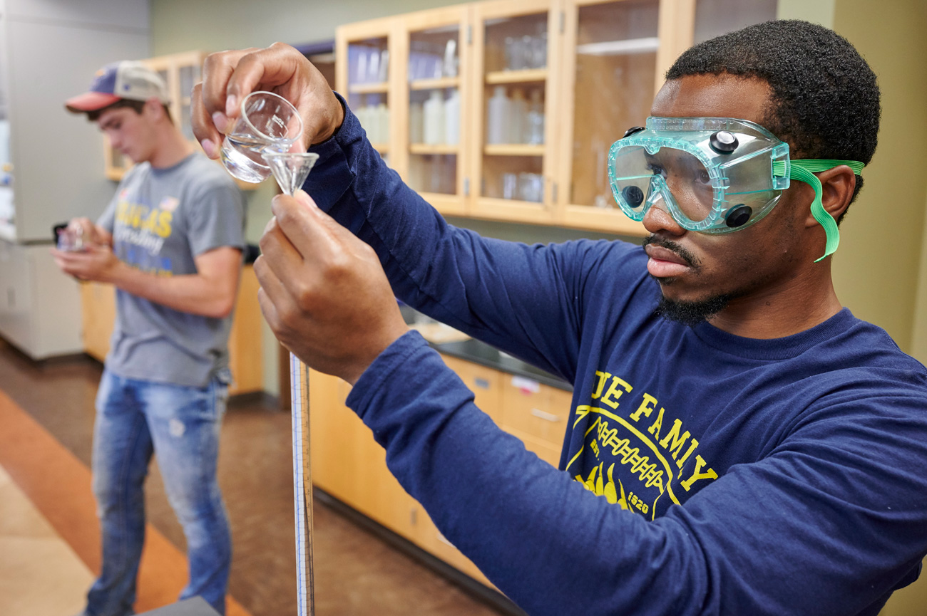 Two males chemistry student working during lab