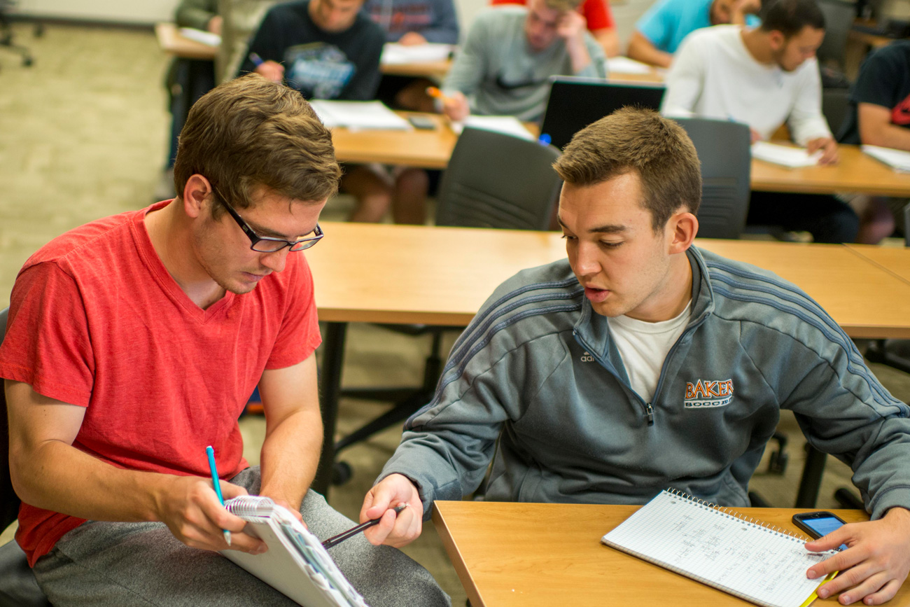 Two male students discussing class assignment together