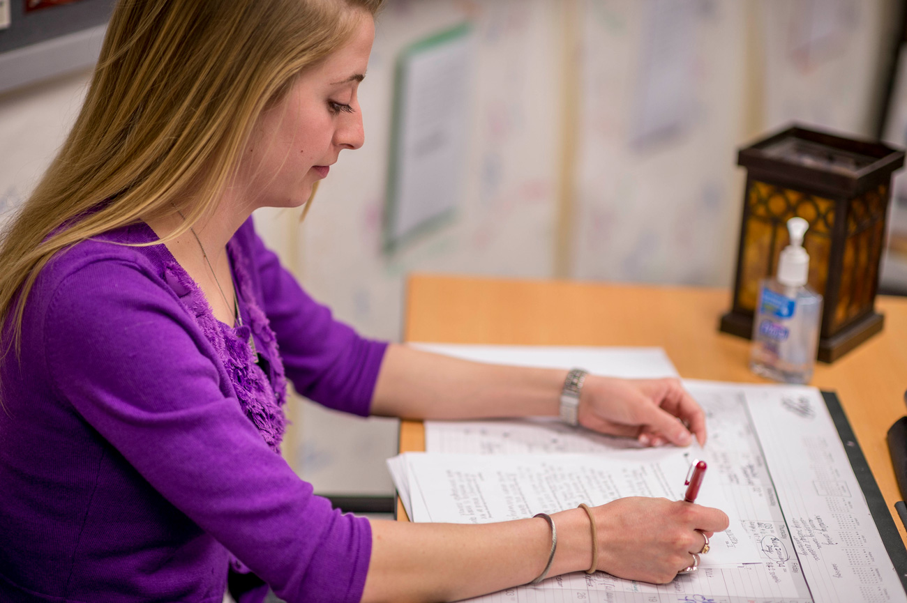 Female teacher working at desk