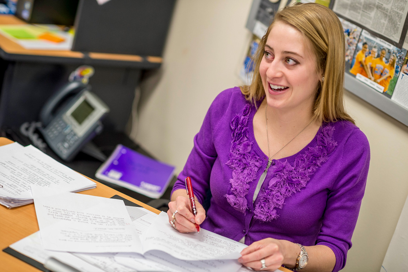 Female teacher grading papers