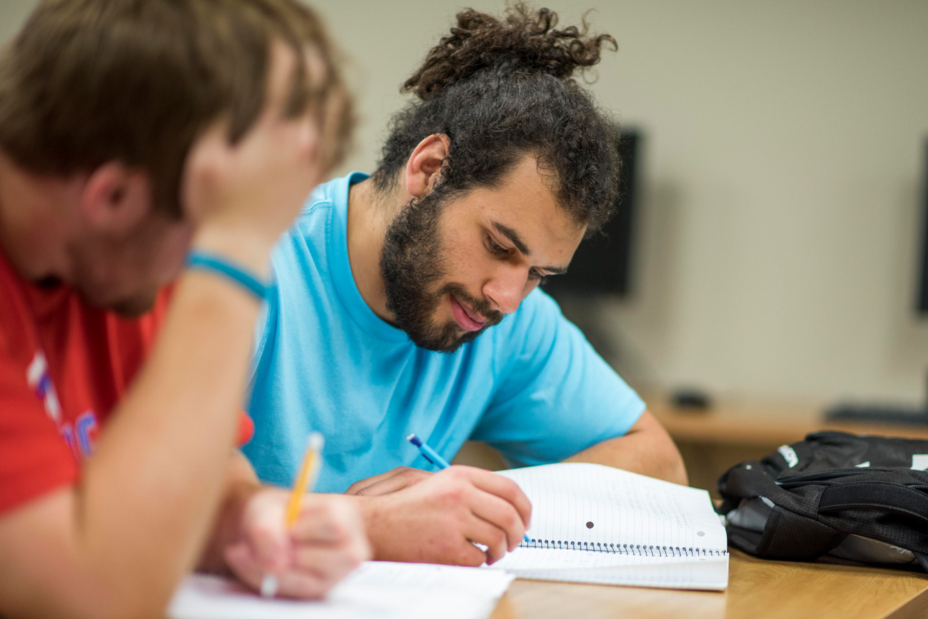 Two male students doing homework together