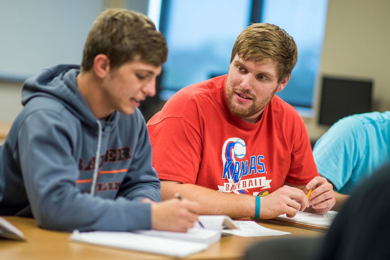 Two male students in discussion during class