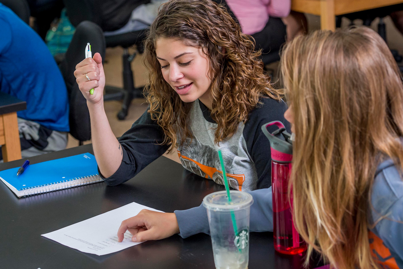 One female student tutoring another female student