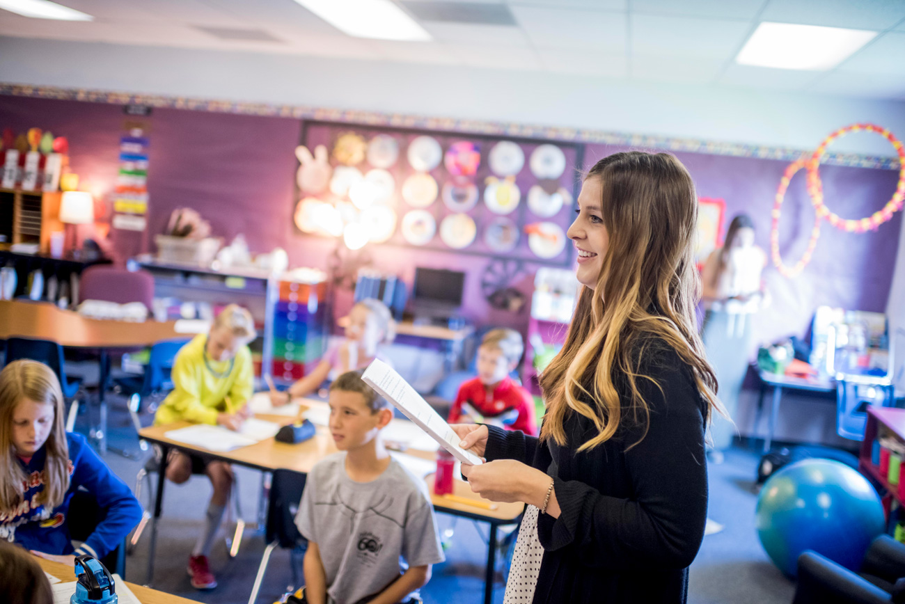 Teacher in elementary school classroom.