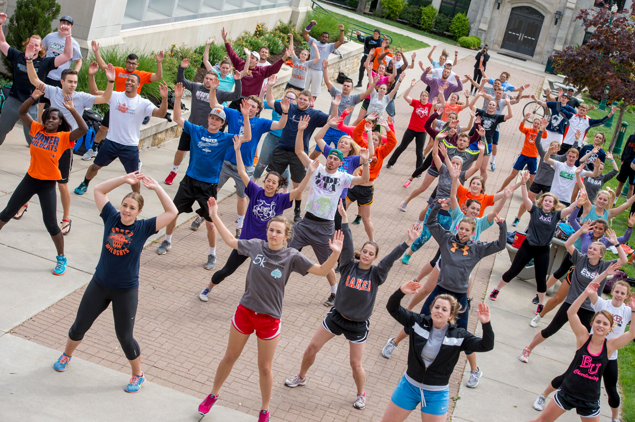 Exercise science students doing morning yoga in Hartley plaza