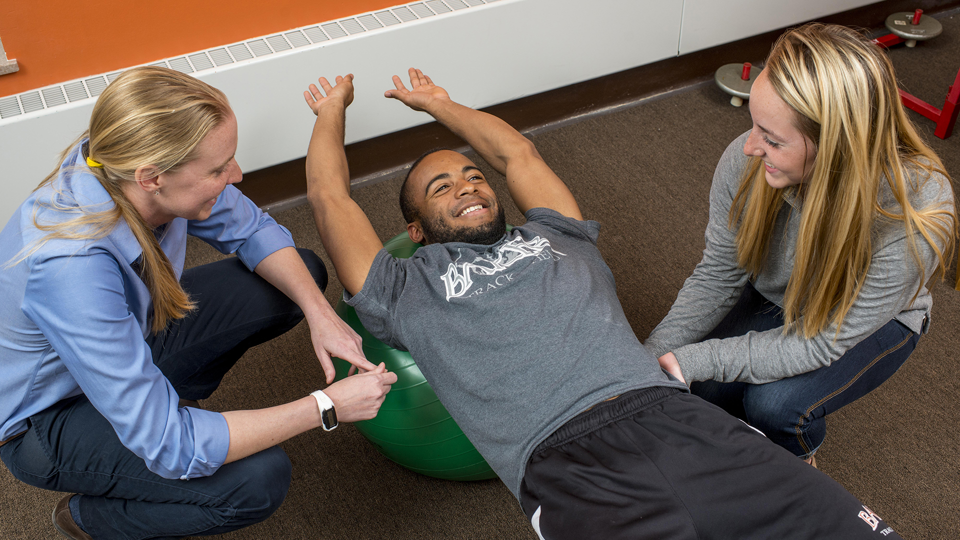 Exercise science students performing hands on activity in class