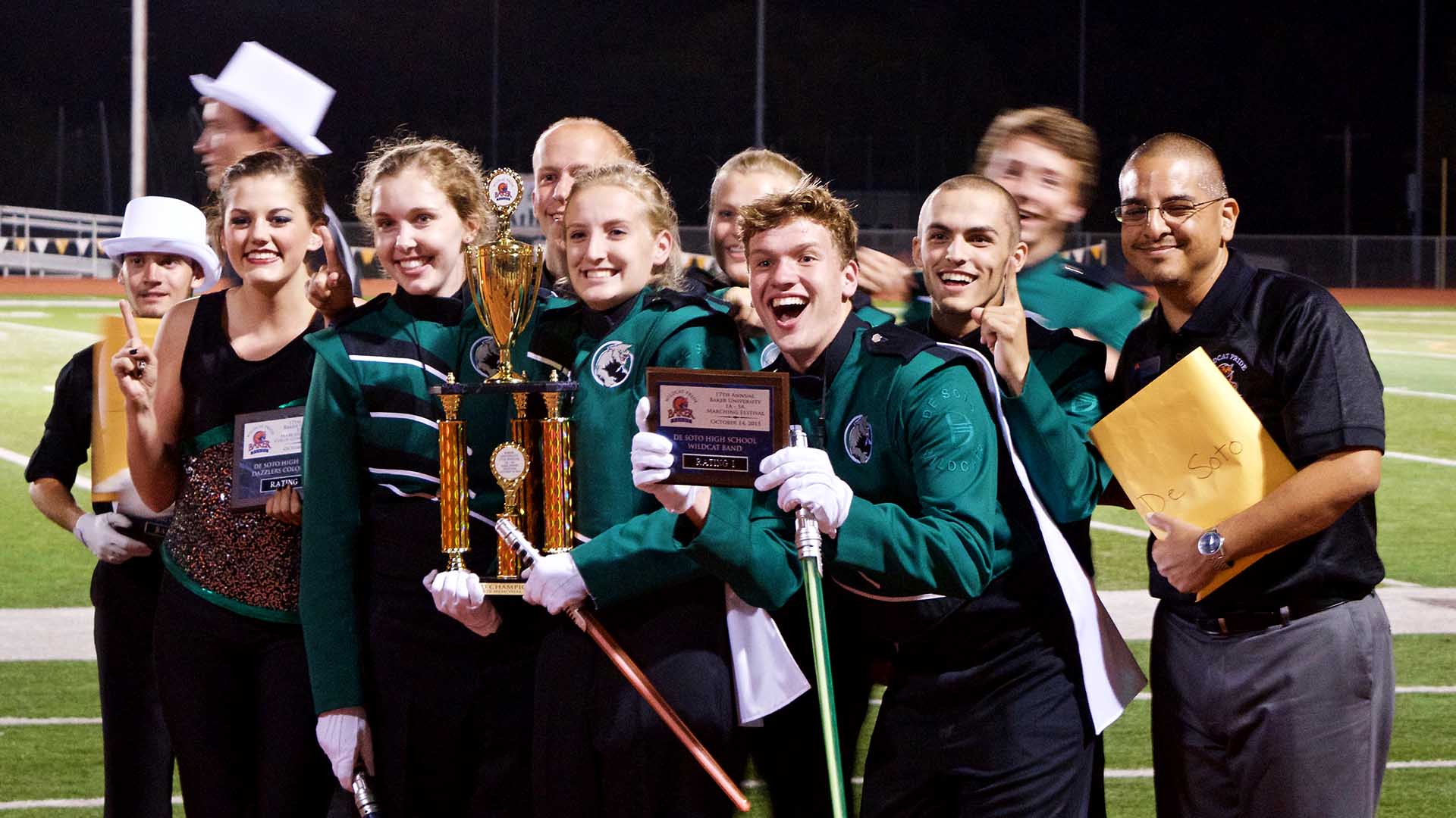 Desoto marching band students holding awards after winning Marching Festival